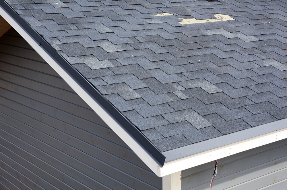 Close-up of shingles damaging the roof