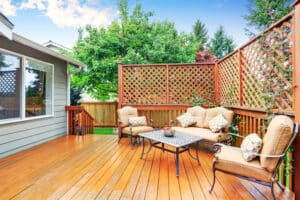 Spacious wooden deck with benches and an attached pergola