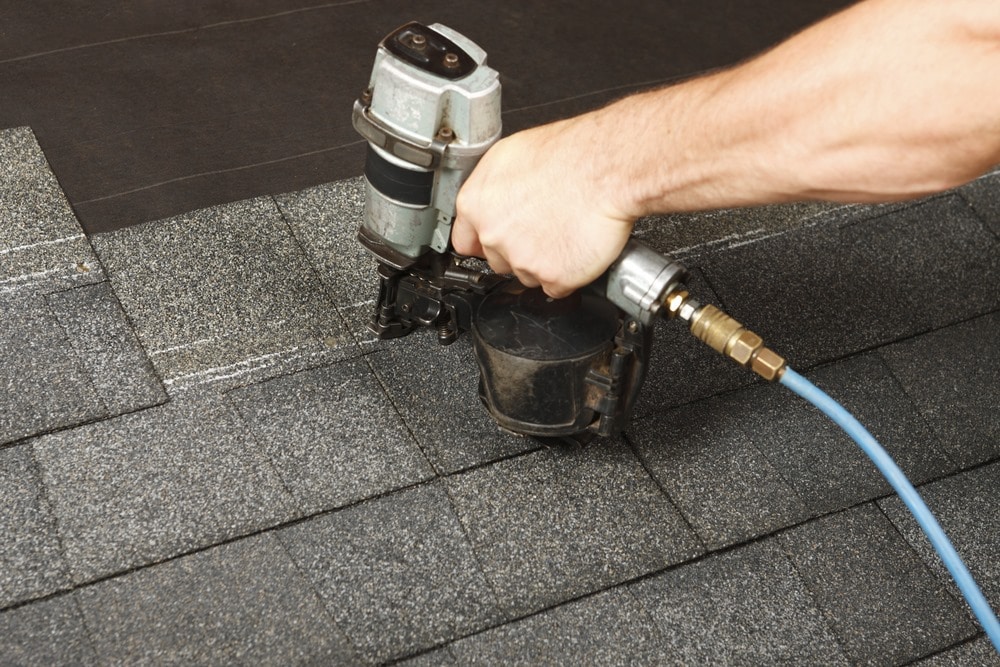 New roof shingle being applied
