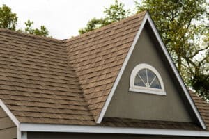 The roof of the house is covered with asphalt shingles