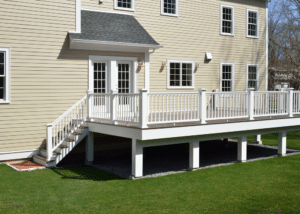 Composite deck with white porch and railing, brown planks raised off the ground