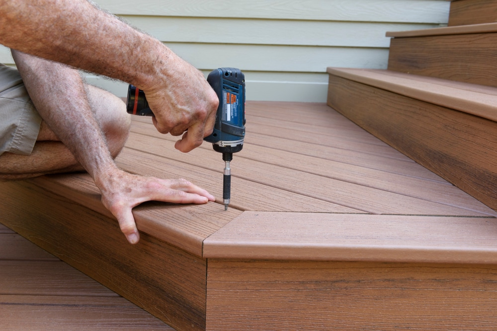 Worker installing composite wood decking