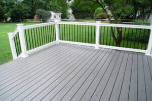 Gray composite deck in the backyard of a residential building