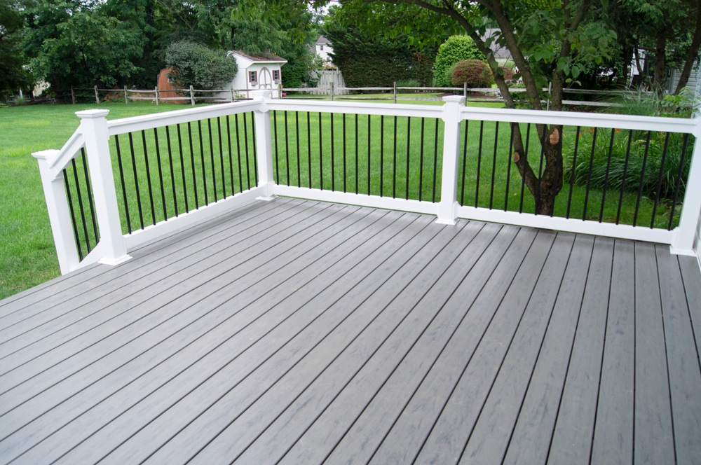 Gray composite deck in the backyard of a residential building