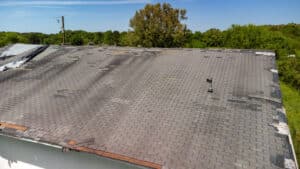 Roof shingles missing due to age, weather and hurricane