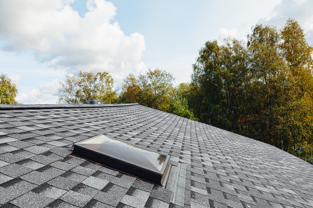 Roof window on shingles flat polymeric roof-tiles