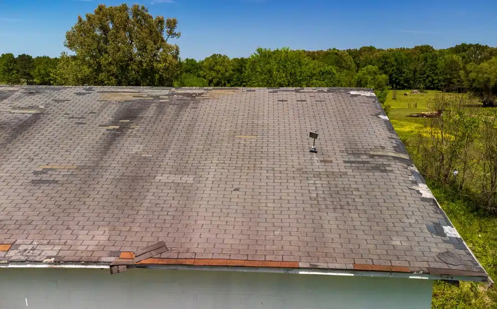 Roof missing shingles due to age, weather and storm damage
