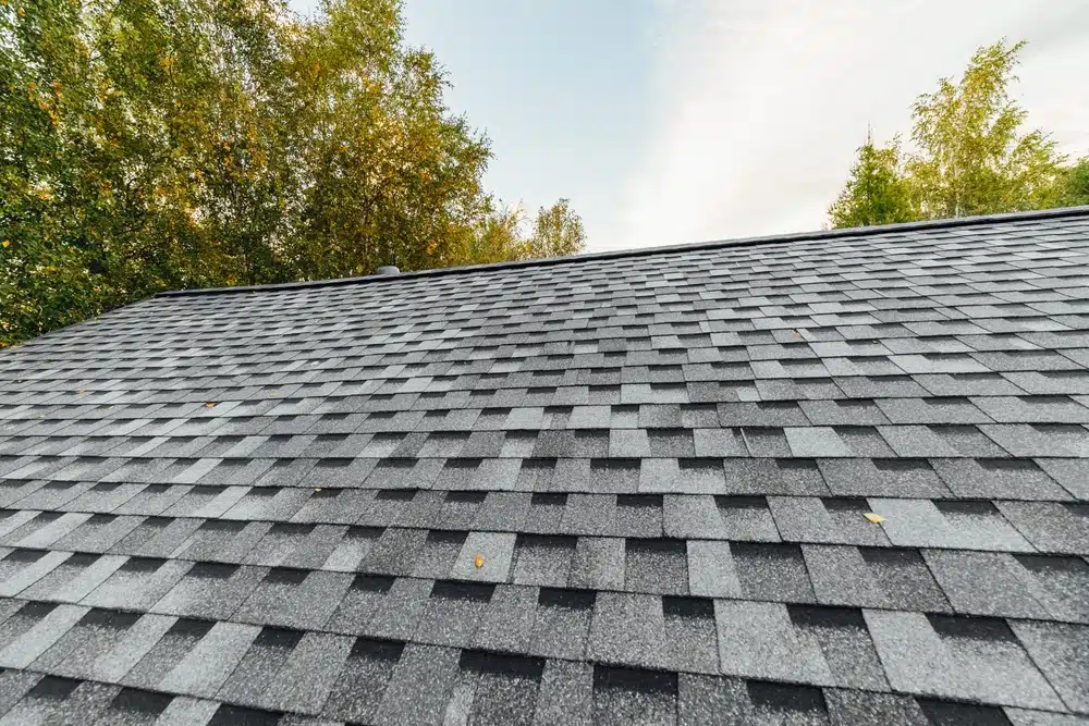 New renovated roof covered with shingles flat polymeric roof-tiles
