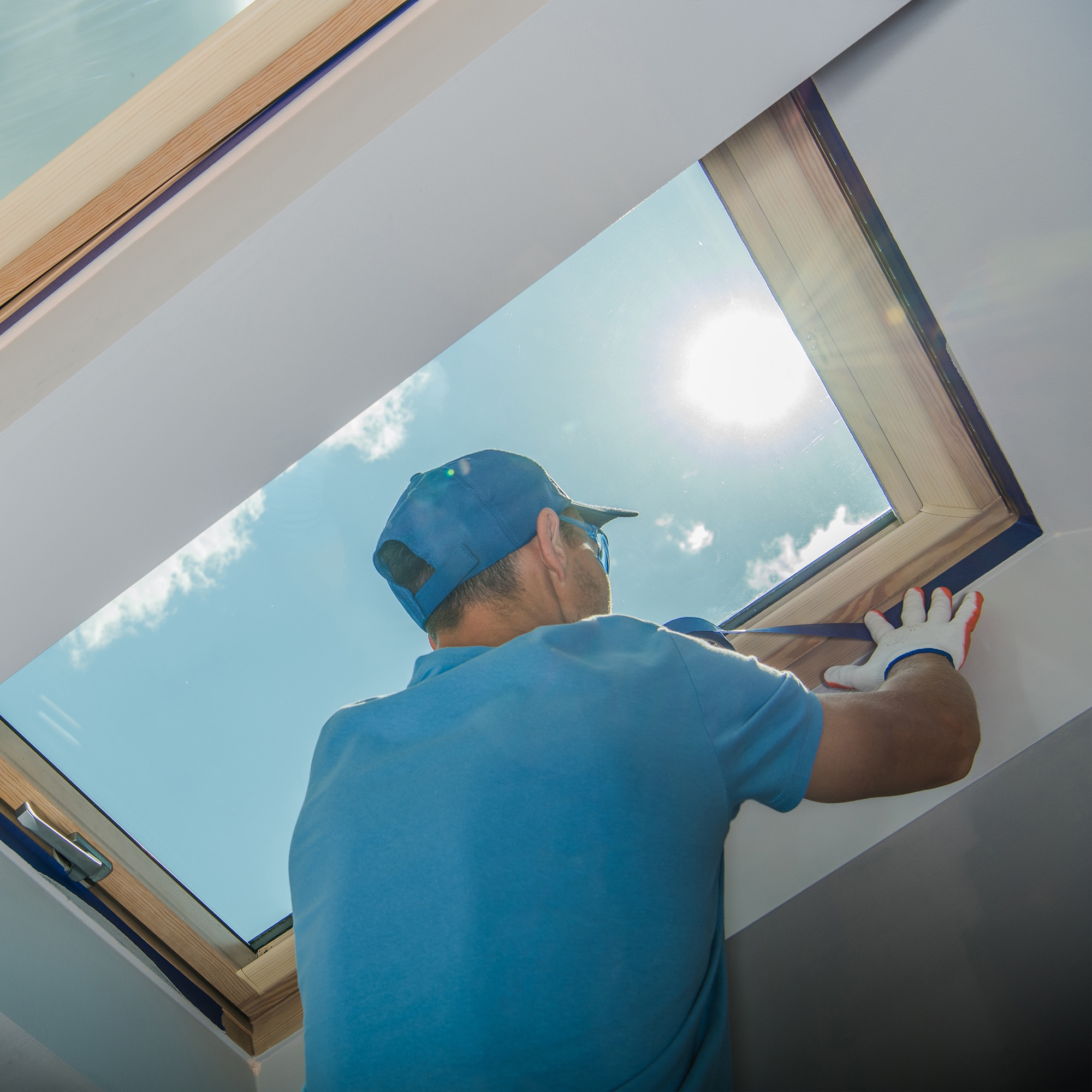 Expert team carefully installing a skylight on a rooftop
