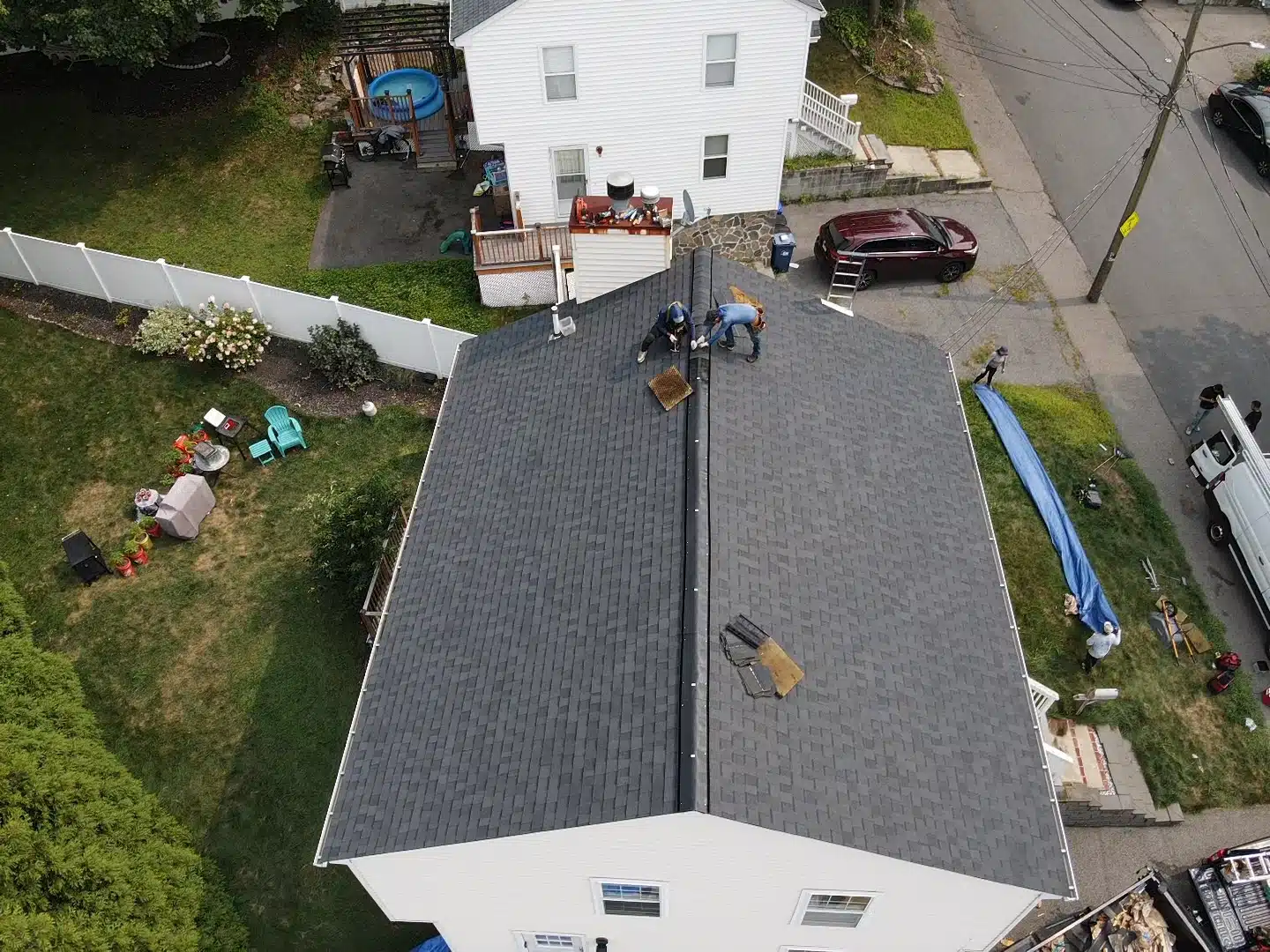 Handymen working together to repair a roof leak