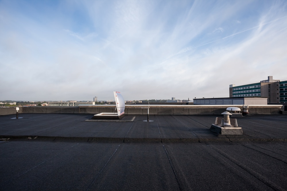 Alt tag text - Plastic dome on a flat roof on a large building 
