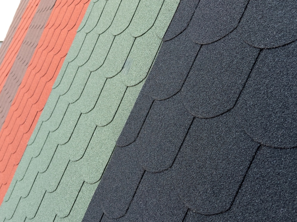 The sloped roof features a variety of colored shingles, including green, red, and black tiles
