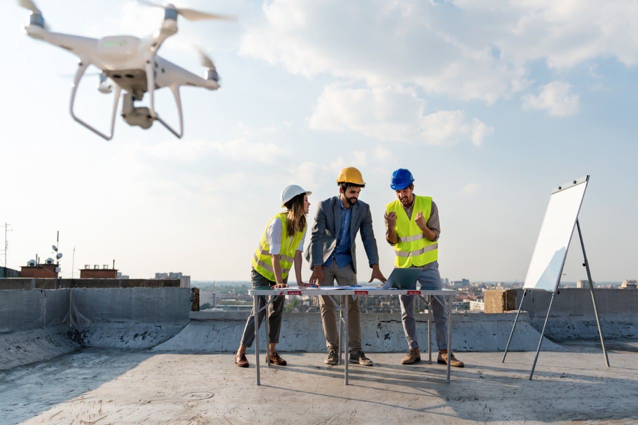 Group of Roofing Experts Inspecting Roof with Drone and Discussing about Roofing Project, Checking Documents

