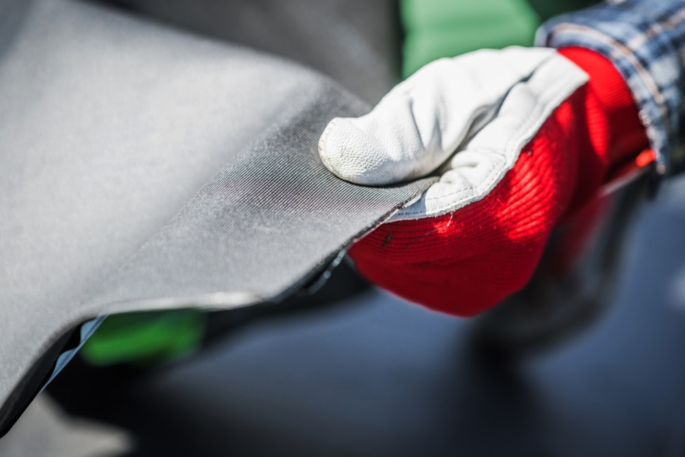 EPDM rubber roof material in the hands of a worker
