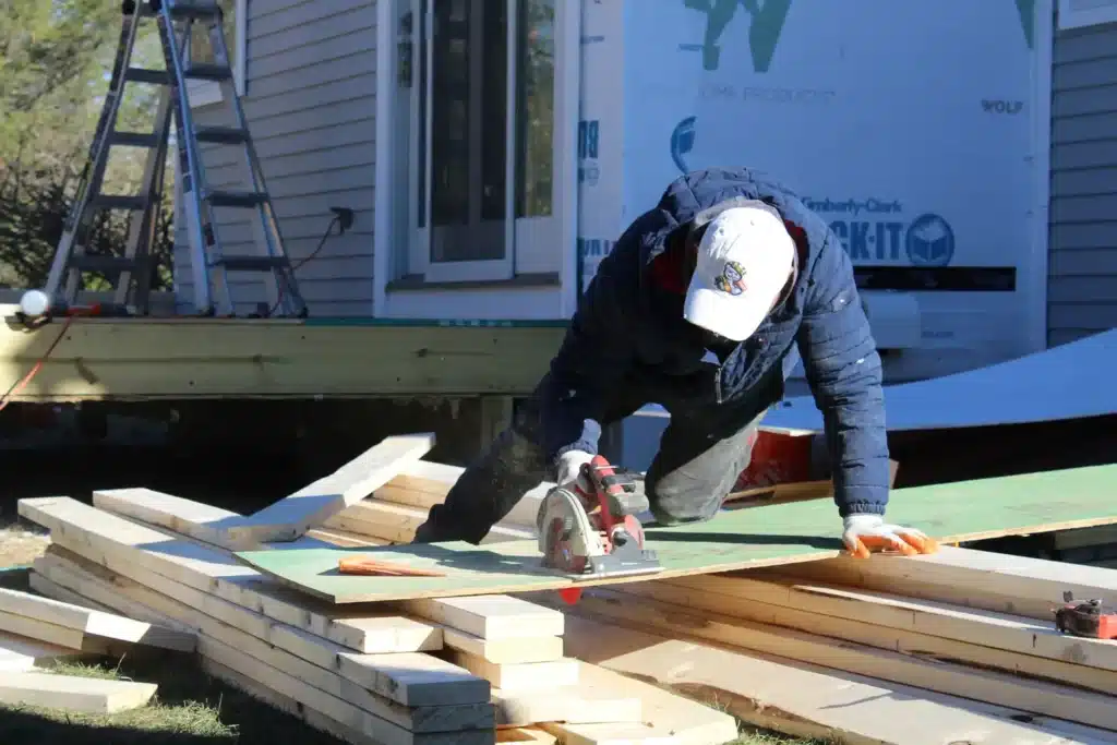 CANRoof Construction team working on roof installation, two male roofing contractors in working clothes