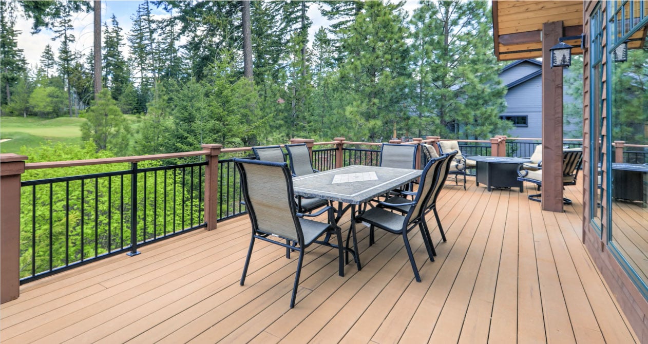 Custom-built deck with wood flooring and black railings, showcasing expert deck building in Boston for a stylish outdoor space