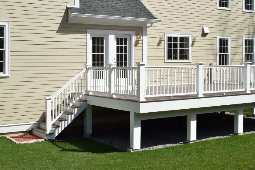 Custom-built deck with white railings and stairs, enhancing outdoor living space with expert deck building in Boston