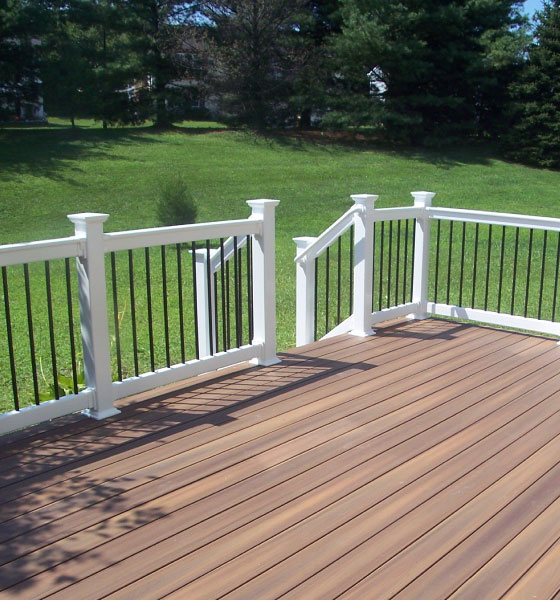 Expert deck building solutions in Boston with durable composite wood and elegant white railings for a stylish outdoor space