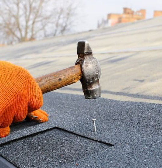 Professional roofer installing asphalt shingles with precision, ensuring durable and weather-resistant roofing Boston MA