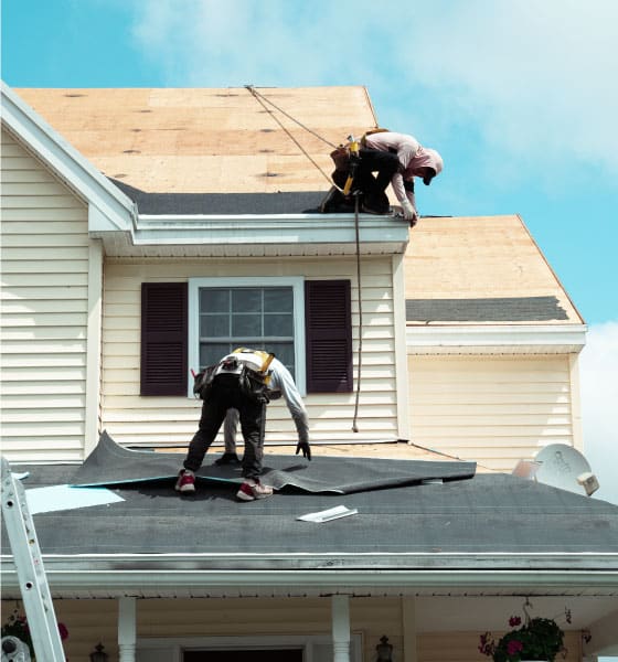 Professional Boston roofers performing a roofing solutions, ensuring durability and weather protection for a residential home