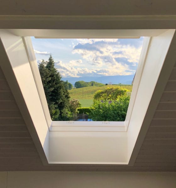 A newly skylight installation in Boston providing a clear view of the sky and green landscape, enhancing natural light