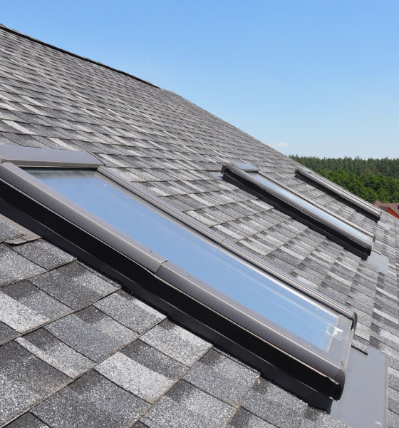 Energy-efficient skylight solutions installed on a shingle roof, enhancing natural light and ventilation for a modern home