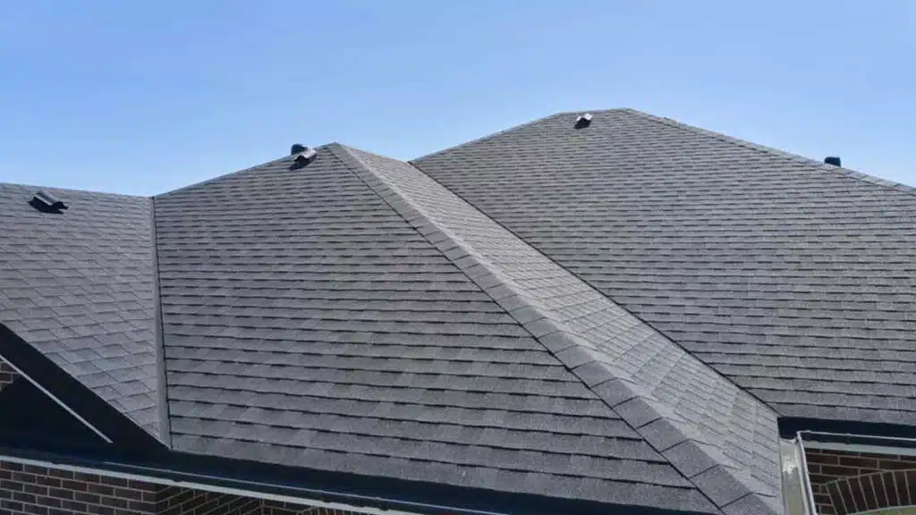Aerial view of a residential roof with asphalt shingles, showcasing proper roof ventilation and modern roofing materials