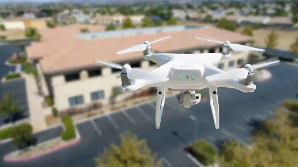 Professional roofing inspection conducted with drone in the air near corporate industrial building, flat rooftop