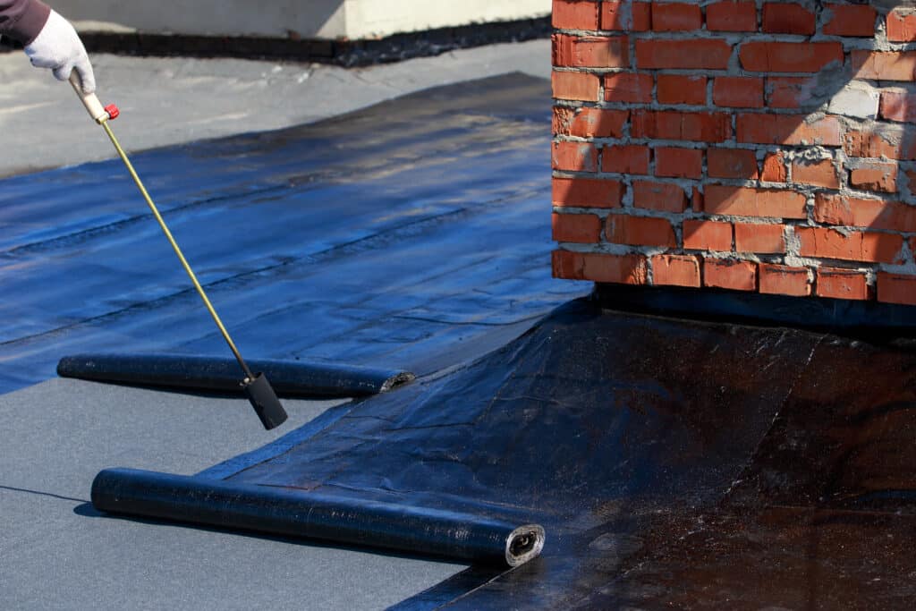 Roof underlayment layer protecting the roof deck
