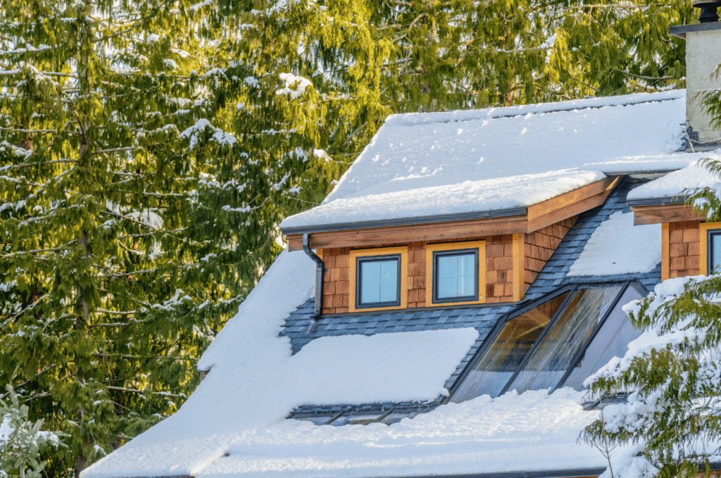 Residential roof with skylights and fresh snow, showing careful roof preparation for winter and insulation planning