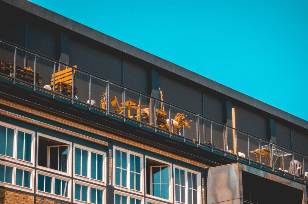 Restaurant roofing with rooftop terrace and safety railing, combining commercial roof design with outdoor dining space