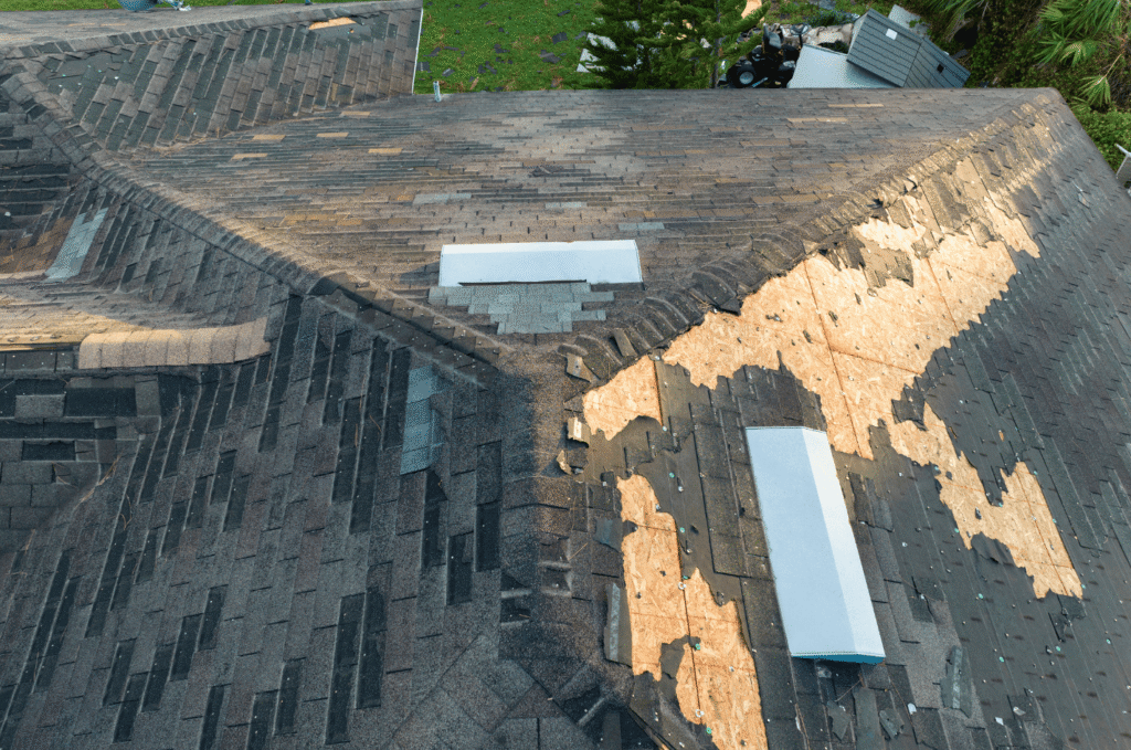 Asphalt shingle roof damage visual showing shingles got ripped and torn off the roof by storm damage