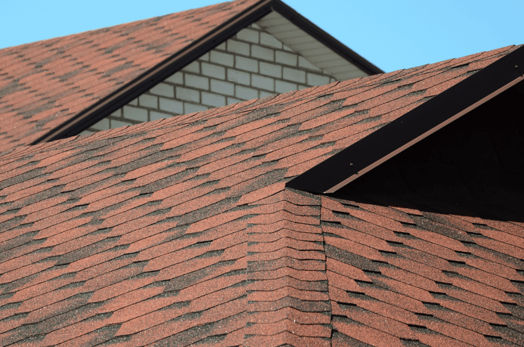 Close view of asphalt shingle roof with dormer, showing the type of roofing work commonly handled by professional roofing companies