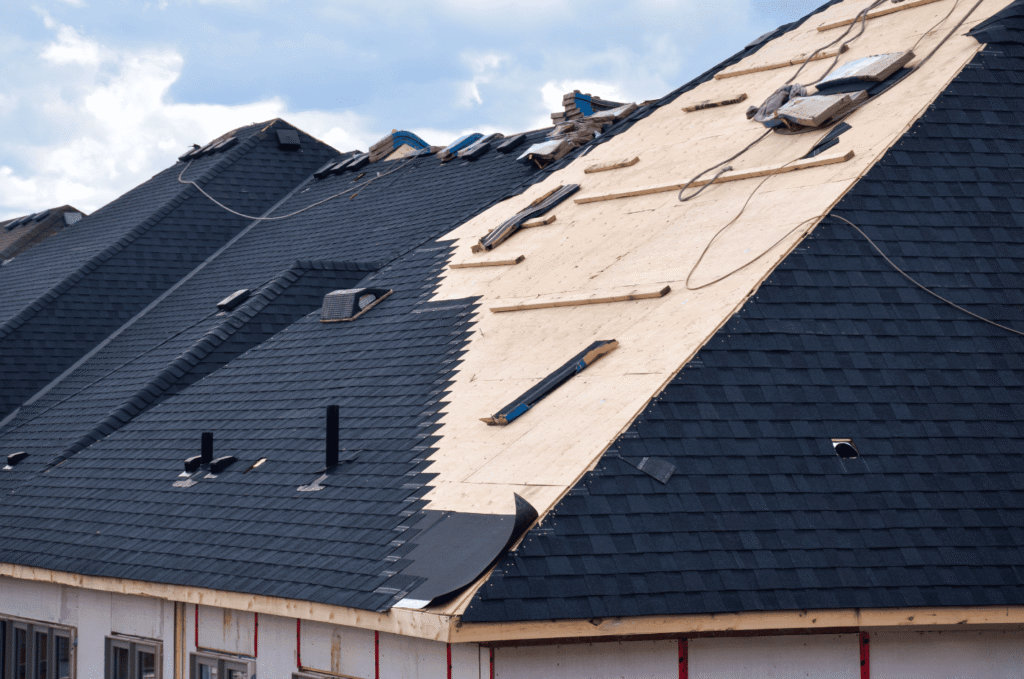 Roof replacement in progress with old materials removed and new layers being installed for better protection