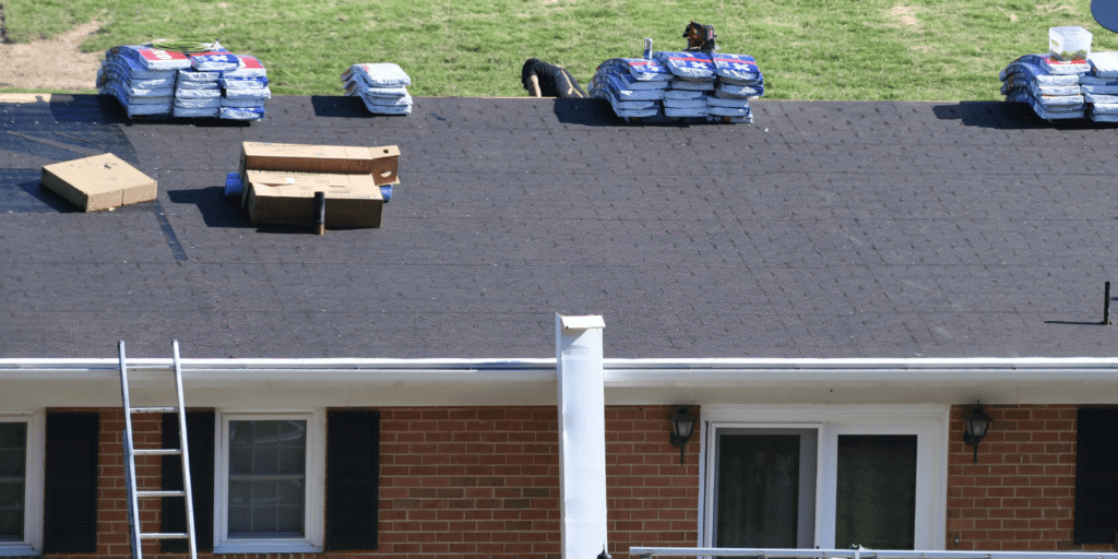 Roof replacement in progress with materials prepared on top, showing early stages of new roof installation