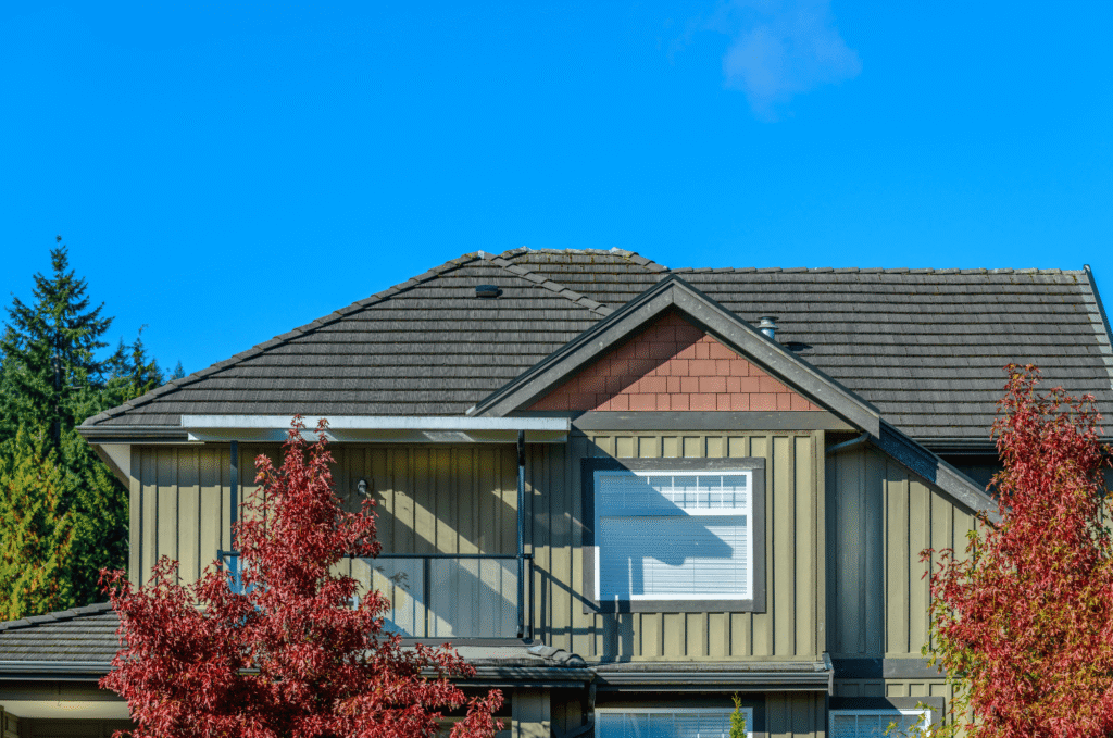 Residential home with new shingles installed by roofing constructors, giving the house better protection and style