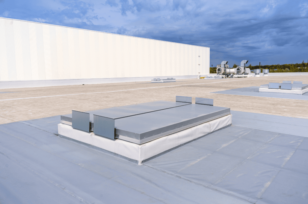 Modern commercial flat roofing system with sealed skylight, built with durable tpo roof material for long-term protection