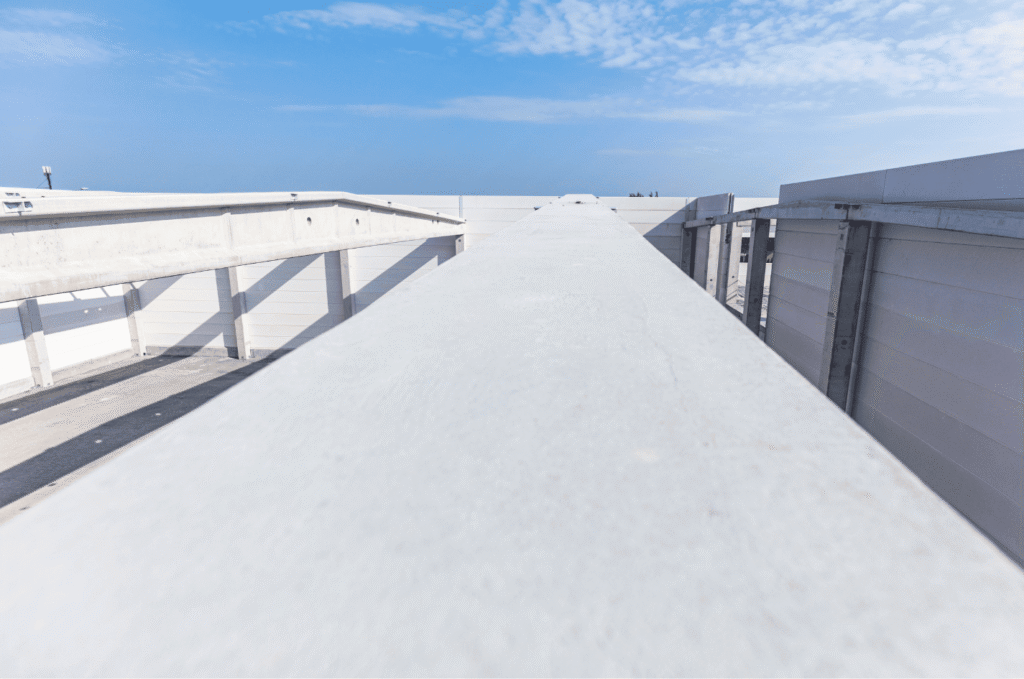 Wide view of a clean flat roofing system with bright TPO roof surface, built to handle sun, rain, and changing weather.