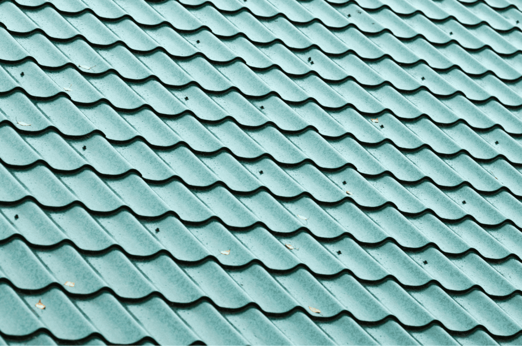 Green metal roofing materials installed in neat rows, showing a durable and weather-resistant roof surface