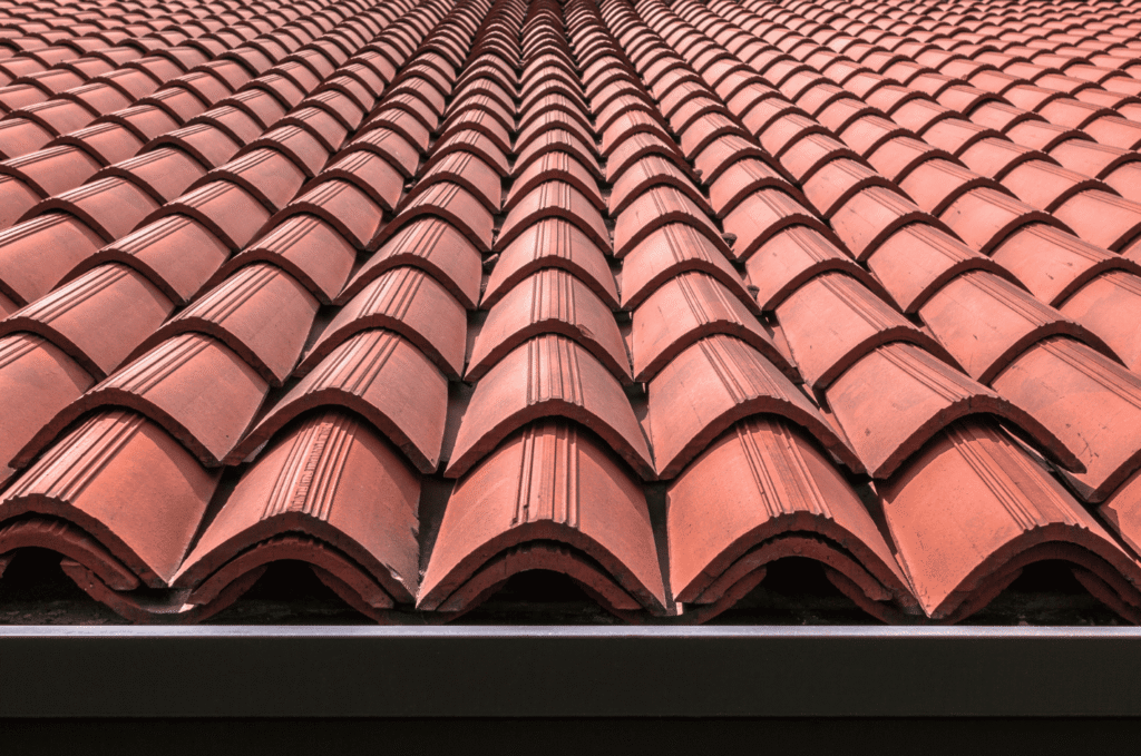 Red clay tile roofing materials arranged in rows, known for long-lasting performance and classic roof design