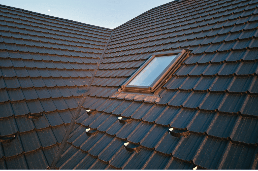 Tile roof with skylight shown during a roof inspection to check sealing around the window and ensure proper drainage