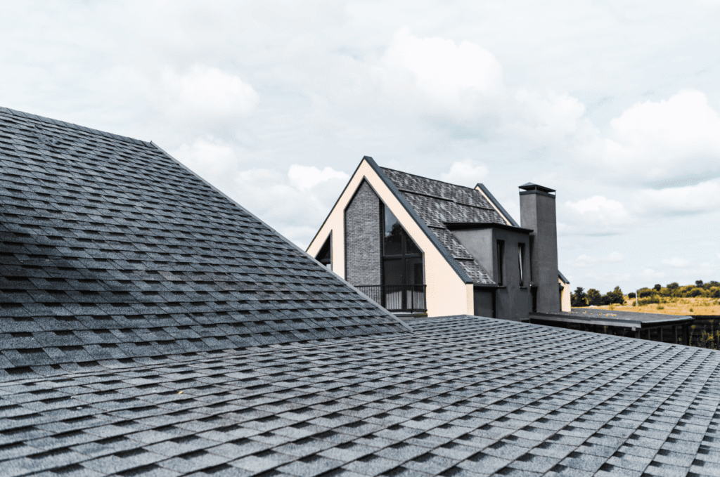Modern home roof with clean shingles shown as part of regular roof maintenance to keep surfaces strong and weather resistant