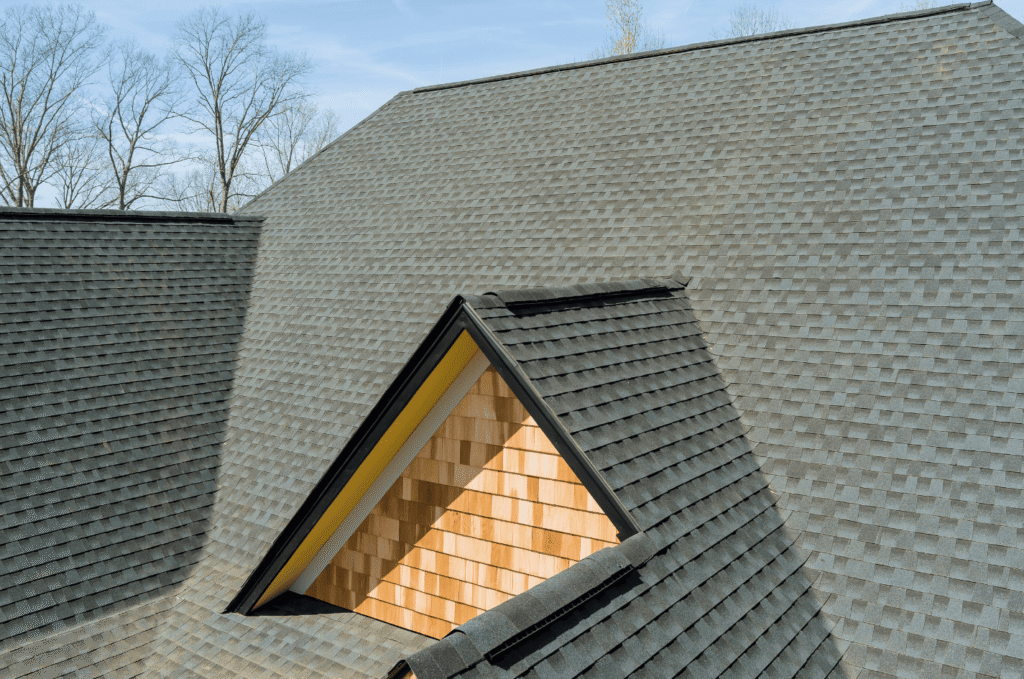 Detailed view of a dormer on an asphalt shingle roof showing proper shingle placement for long-lasting roof protection