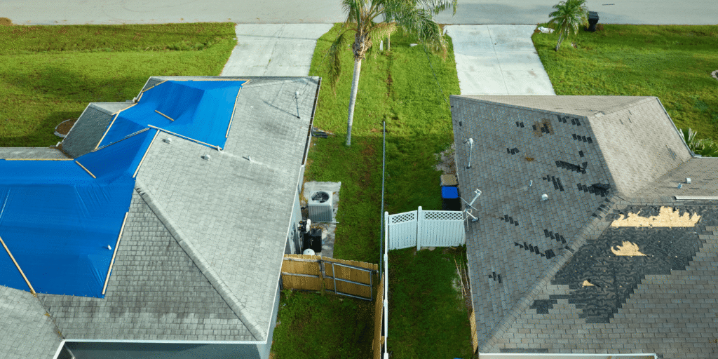 Homeowner applying a temporary roof leak fix with a tarp and roofing cement to prevent water damage during a storm