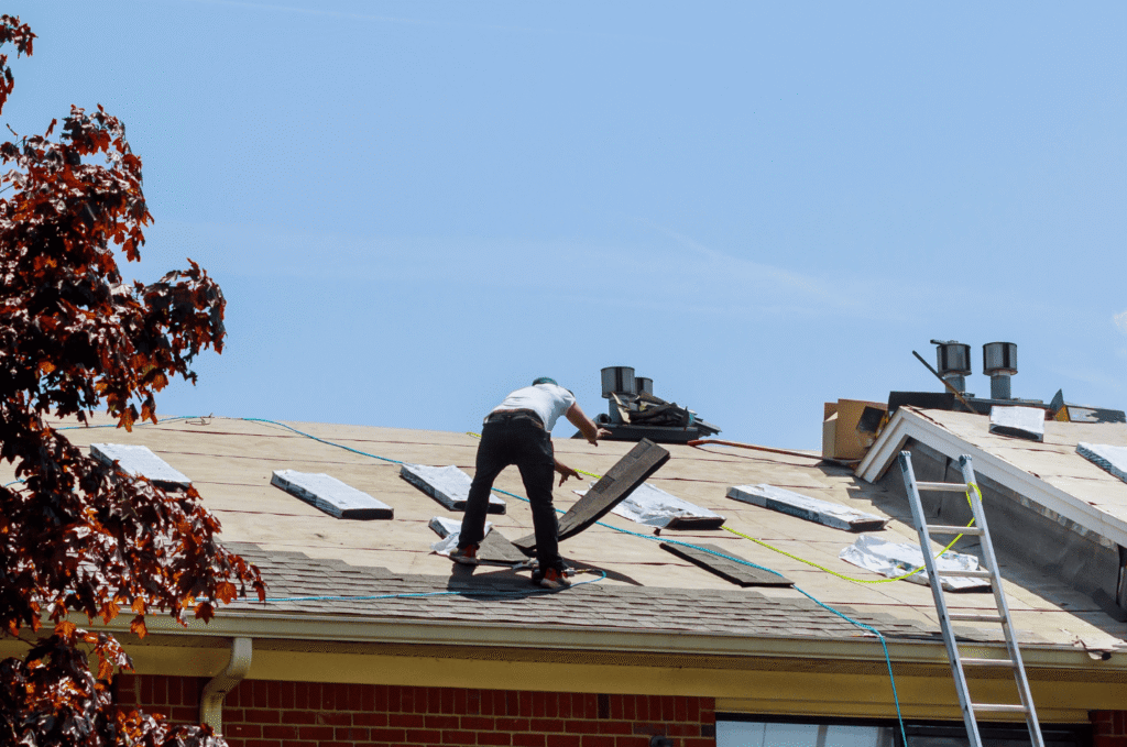 Roof installation tear-off and deck repair in progress on a residential home before new shingle application
