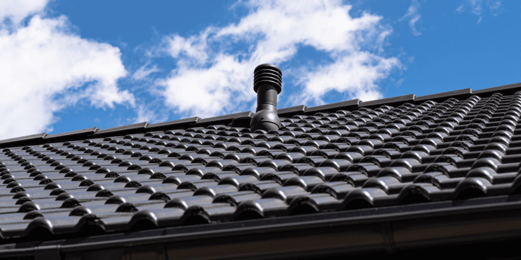 Roof vents on a Boston home roof under a clear blue sky, showing attic airflow and proper ventilation across the roof system