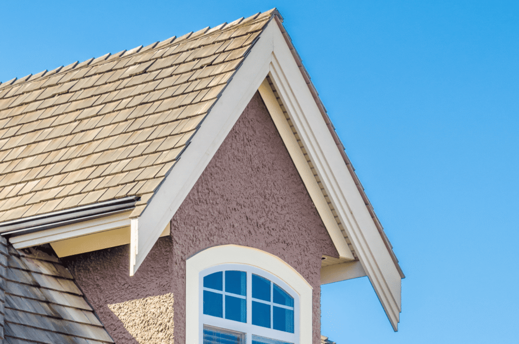 Roof window and eaves on a Boston home, showing exterior areas where blocked soffits can affect roof vents and attic airflow