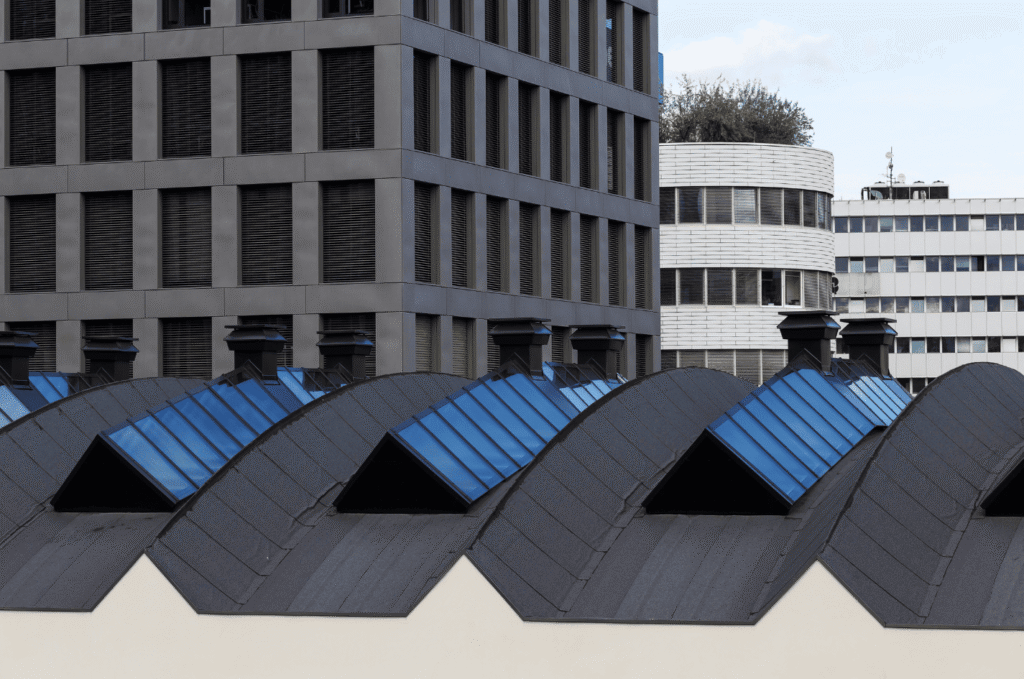 Commercial rooftop equipment and pipes, showing roof penetrations, flashing, and seals where commercial roof leaks can start 