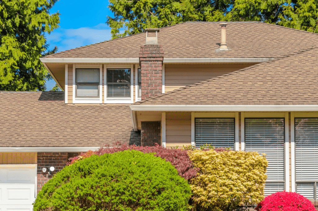 Residential shingle roof with roof edges and chimney showing areas that may need inspection before hidden leak risks spread