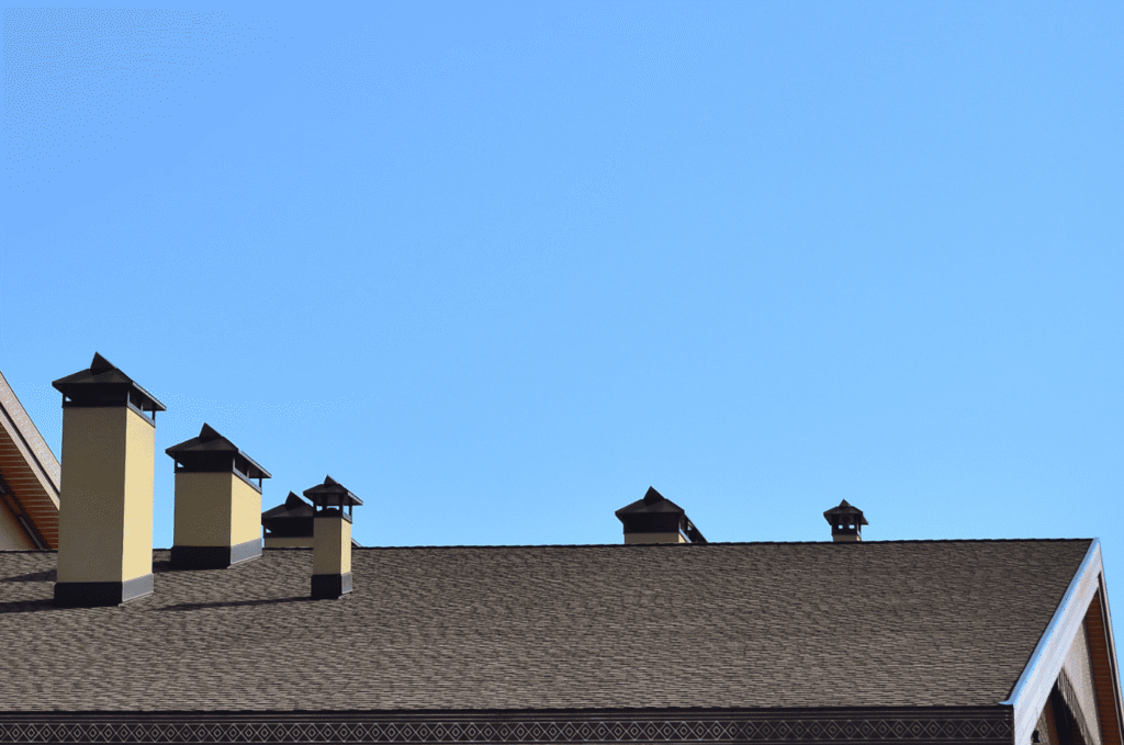 Roof exhaust vents along the ridge of a Boston home, the outlet side of the attic ventilation path that releases hot air